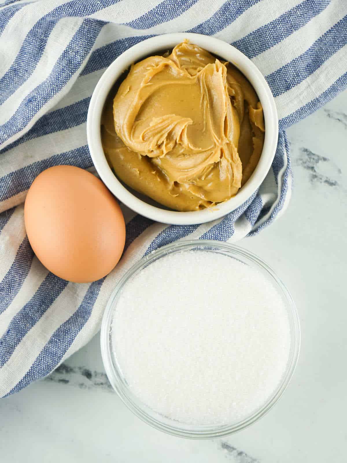 Bowls of peanut butter, sucralose, and an egg.